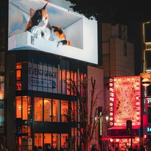Creative digital billboard lighting up a busy city street at night, showing how Jam Billboards Calgary stands out in urban advertising
